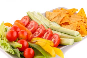 Nachos and vegetables isolated on white background.