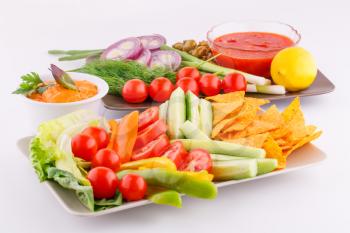 Vegetables, olives, nachos, red and cheese sause image.
