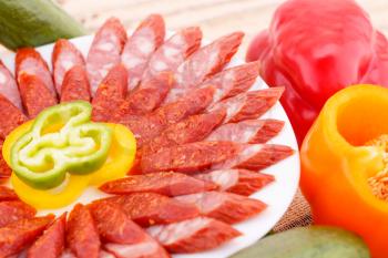 Fresh sausages and vegetables closeup picture.