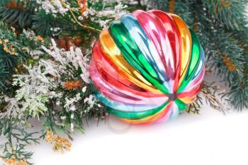 Christmas colorful ball, fir-tree branch on white background.