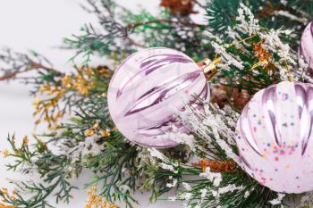 Christmas decoration with pink balls and fir-tree branch.