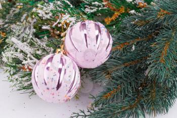 Christmas decoration with pink balls and fir-tree branch.