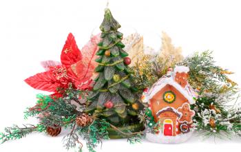 Fir tree candle, toy house and holly berry flower on white background.