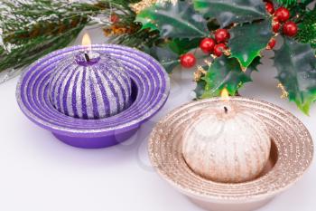 Christmas candles and decoration on gray background.