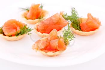 Salmon rolled fillet in pastries on plate.