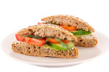 Sandwiches with fresh vegetables and cheese on plate.