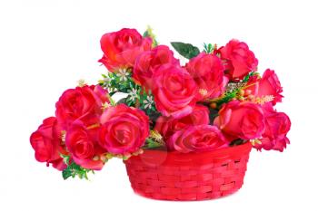 Red fabric roses in wicker basket isolated on white background.