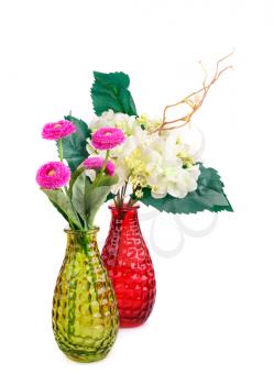 Pink and white fabric flowers in vases isolated on white background.