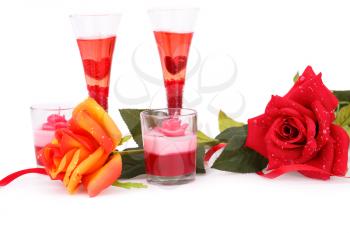 Four glasses, candles and roses  isolated on white background.