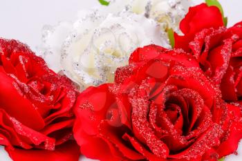 Red and white fabric roses closeup picture.
