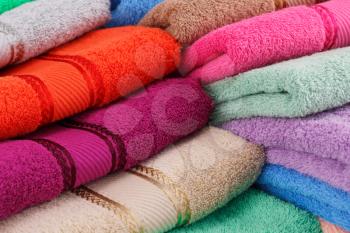 Colorful folded towels stack closeup picture.