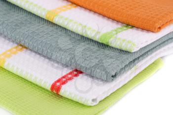 Stack of colorful kitchen towels closeup picture.