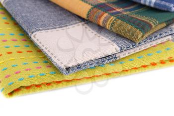 Stack of colorful kitchen towels on white background.