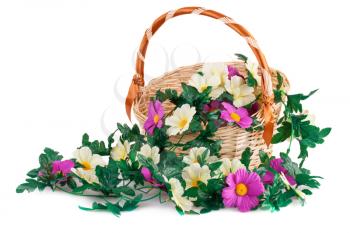 Fabric flowers in wicker basket isolated on white background.