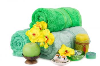 Spa set with towels, candles and flowers isolated on white background.