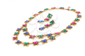 Stylish necklace and earrings with colorful stones isolated on white background.