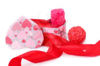 Red ribbon,  candles and gift box isolated on white background.
