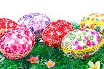 Easter eggs on artificial grass and white background.