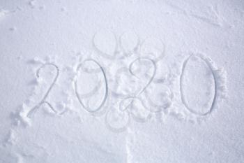 Fresh falling snow texture with 2020 as a background.