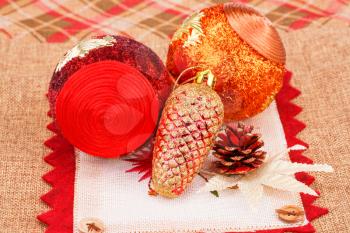Christmas red balls with cones on canvas background.