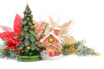 Fir tree candle, toy house and holly berry flowers on white background.