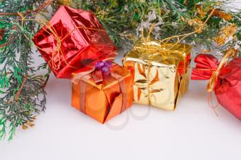 Christmas boxes and fir tree branches on gray background.