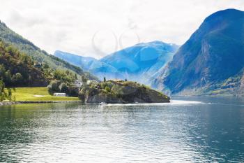 Landscape with Naeroyfjord, mountains and traditional village houses in Norway.