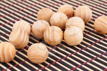 Wooden balls on bamboo background.