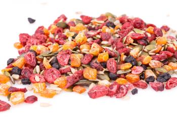 Dried fruits, berries and seeds on white background.