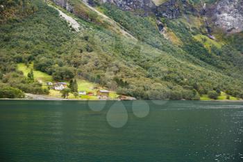 Landscape with Naeroyfjord, mountains and traditional village house in Norway.