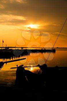 The boats at the sea harbour in the Dutch fisherman village Marken at the sunset.