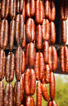 Homemade delicious sausages hanging in line at the market.