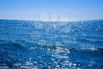 Blue Mediterranean sea with the sparkling surface.