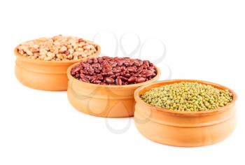 Red kidney, borlotti and mung beans in the ceramic pots isolated on a white background.