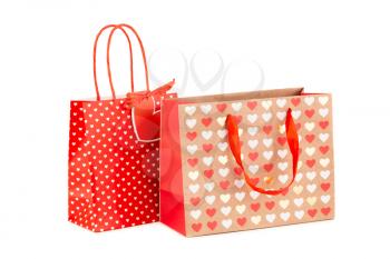 Two shopping bags with hearts pattern isolated on white background.