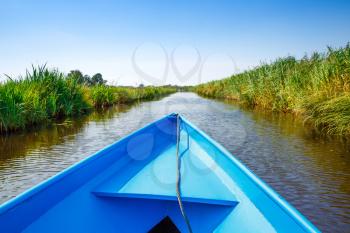 The tourists on the sightseeing boats in the Dutch fairytale village.