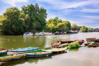 Thames riverfront with many boats in Richmond, London, UK.