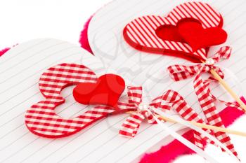 Red hearts with opened notepad on white background.