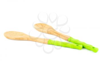 Wooden spoons with green silicone handles isolated on white background.