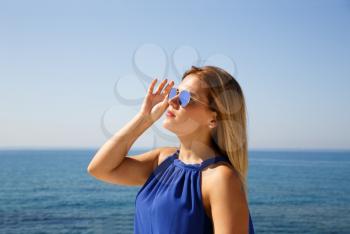 Blond woman in the blue dress at the beach in Cyprus.