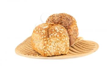Wholegrain bread buns with seeds and oat on wooden tray isolated on white background.