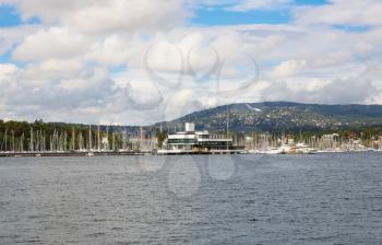 Coastline in Oslo with boats, port and buildings.