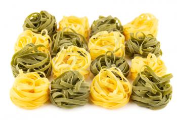 The heap of tagliatelle pasta isolated on white background.
