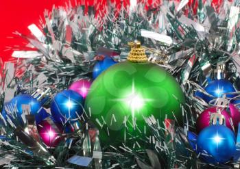Christmas and and New Year decoration- balls, tinsel .On the red background.