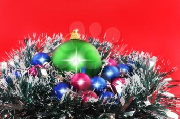 Christmas and and New Year decoration- balls, tinsel .On the red background.