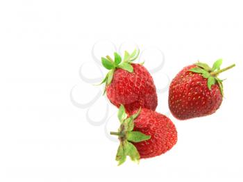 Three fresh strawberries. Isolated over white