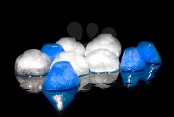 Coloured (blue and white) ice, on black background.