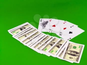 Four aces and dice on green broadcloth (background).