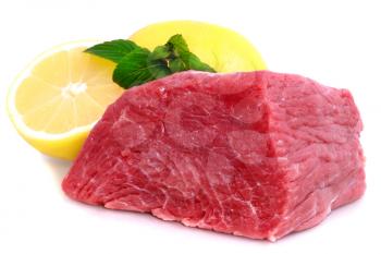 Cut of  beef steak  with lemon slice. Isolated.