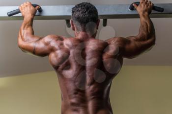 male body builder doing heavy weight exercise for back